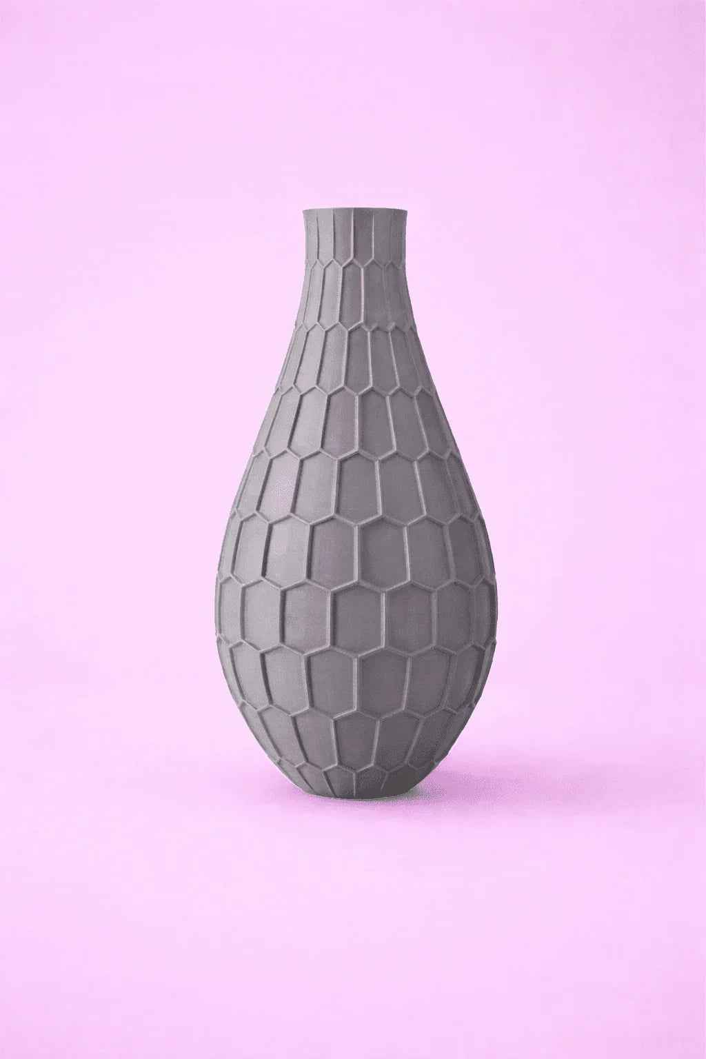Jarrón gris 3D con textura hexagonal sobre fondo rosa, decoración moderna